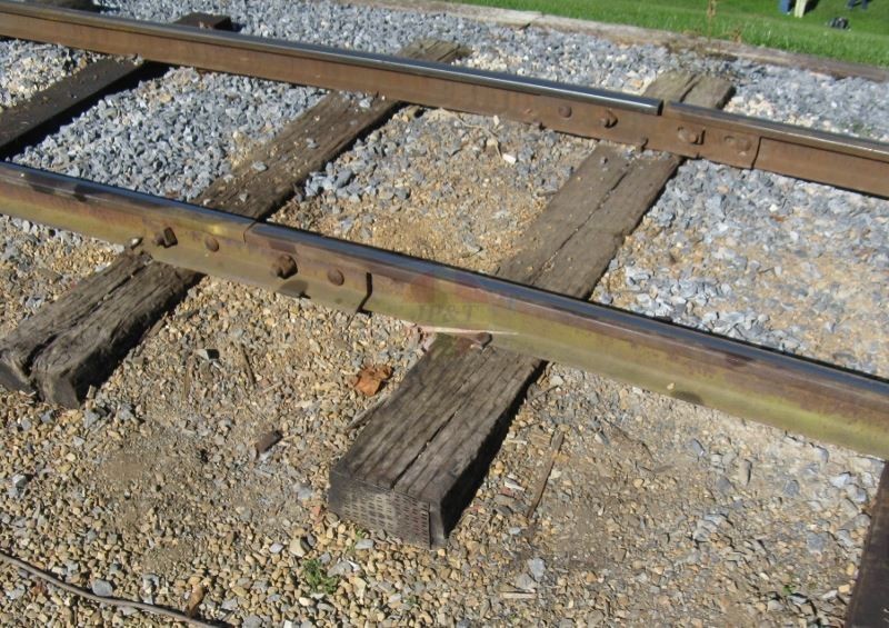 Brown rail inside, green rail outside