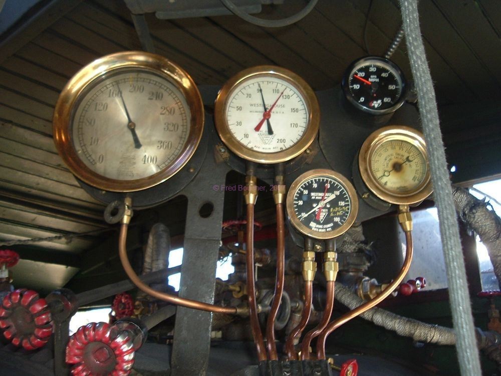 Engineer's gauge cluster, L to R, upper to lower: Steam gauge (167 lbs); air brake gauges; speedometer (17 mph); do not recall the right most brass gauge